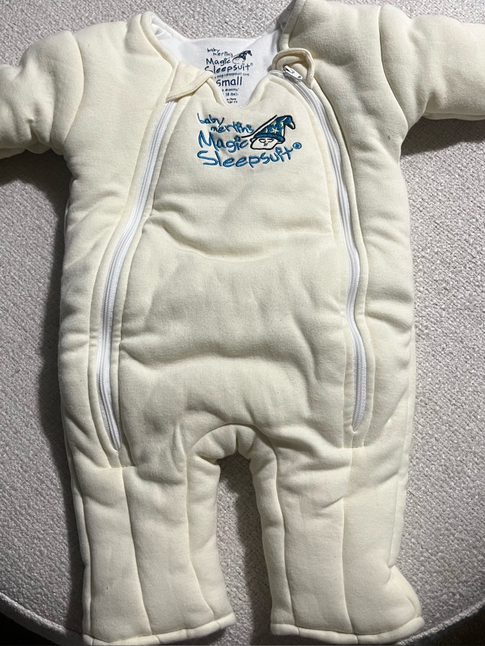 Baby Merlin Magic Sleepsuit in Cream with Blue Logo